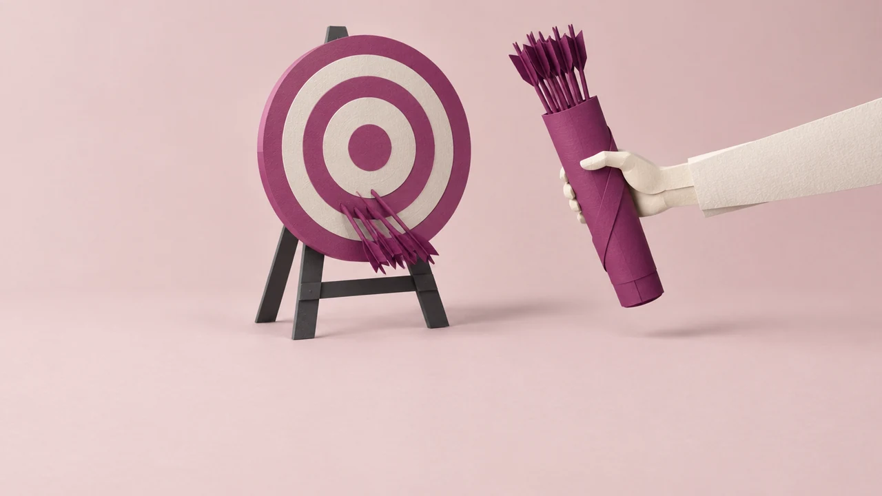 Arrows cluster low on an archery target while a hand holds out a full quiver of new arrows