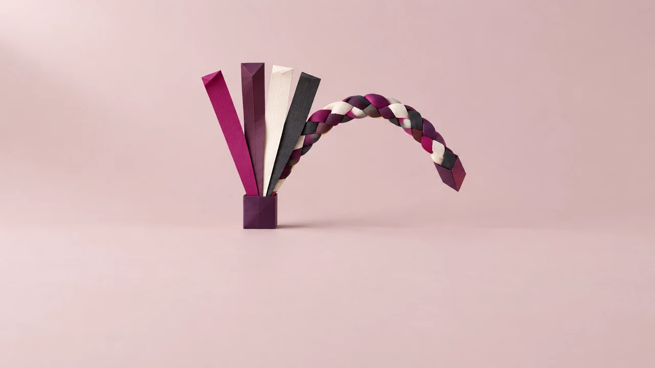 Four paper strips in magenta, plum, white and charcoal fan up from a small base and plait into one braid that arcs over to the right
